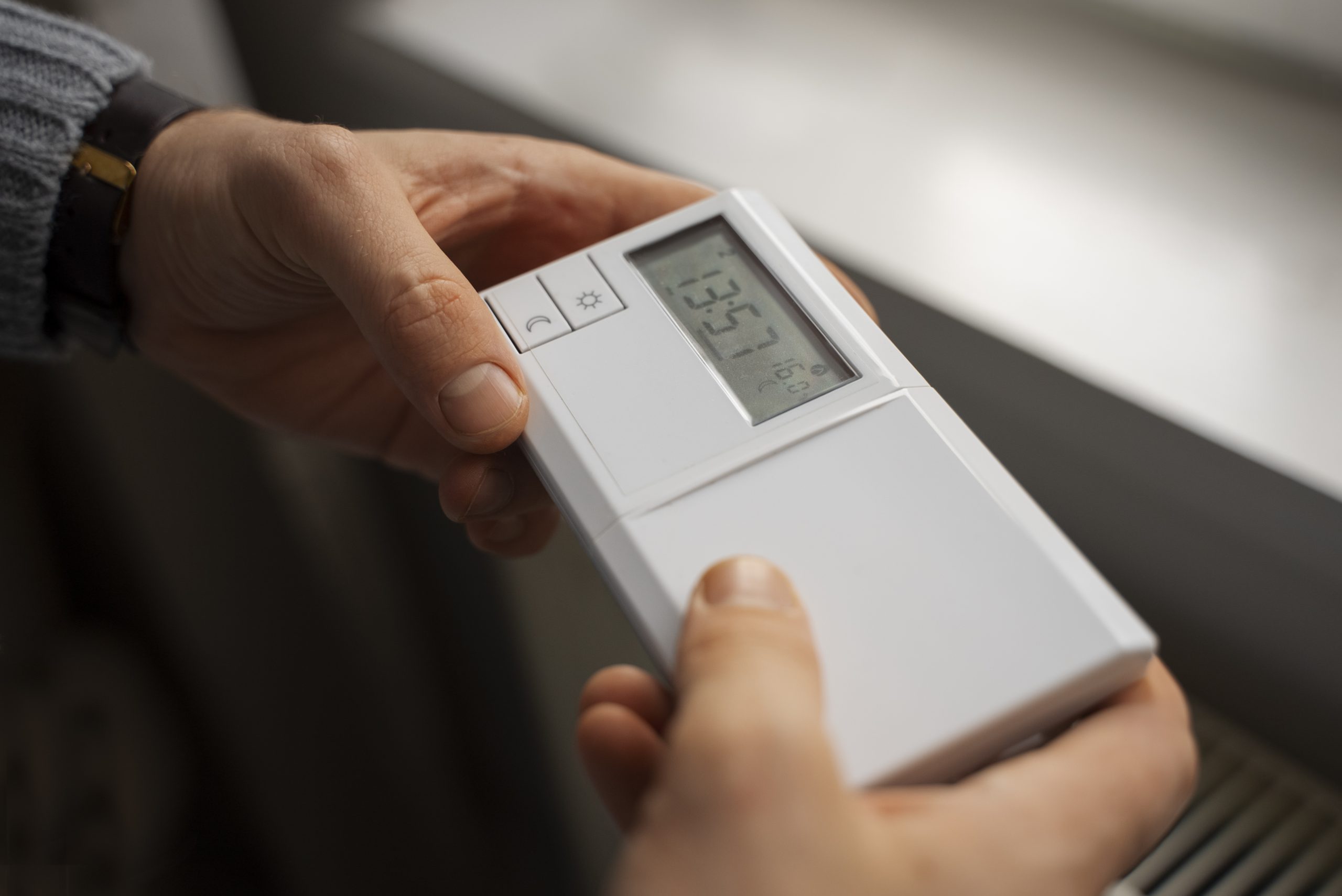 man-turning-off-thermostat-energy-crisis
